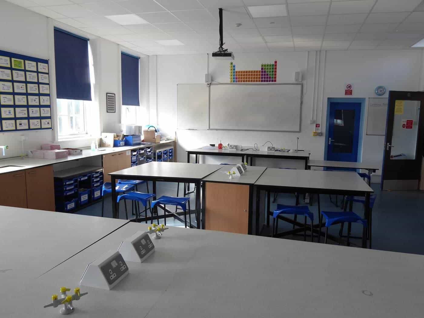 A school science laboratory with benches and stools