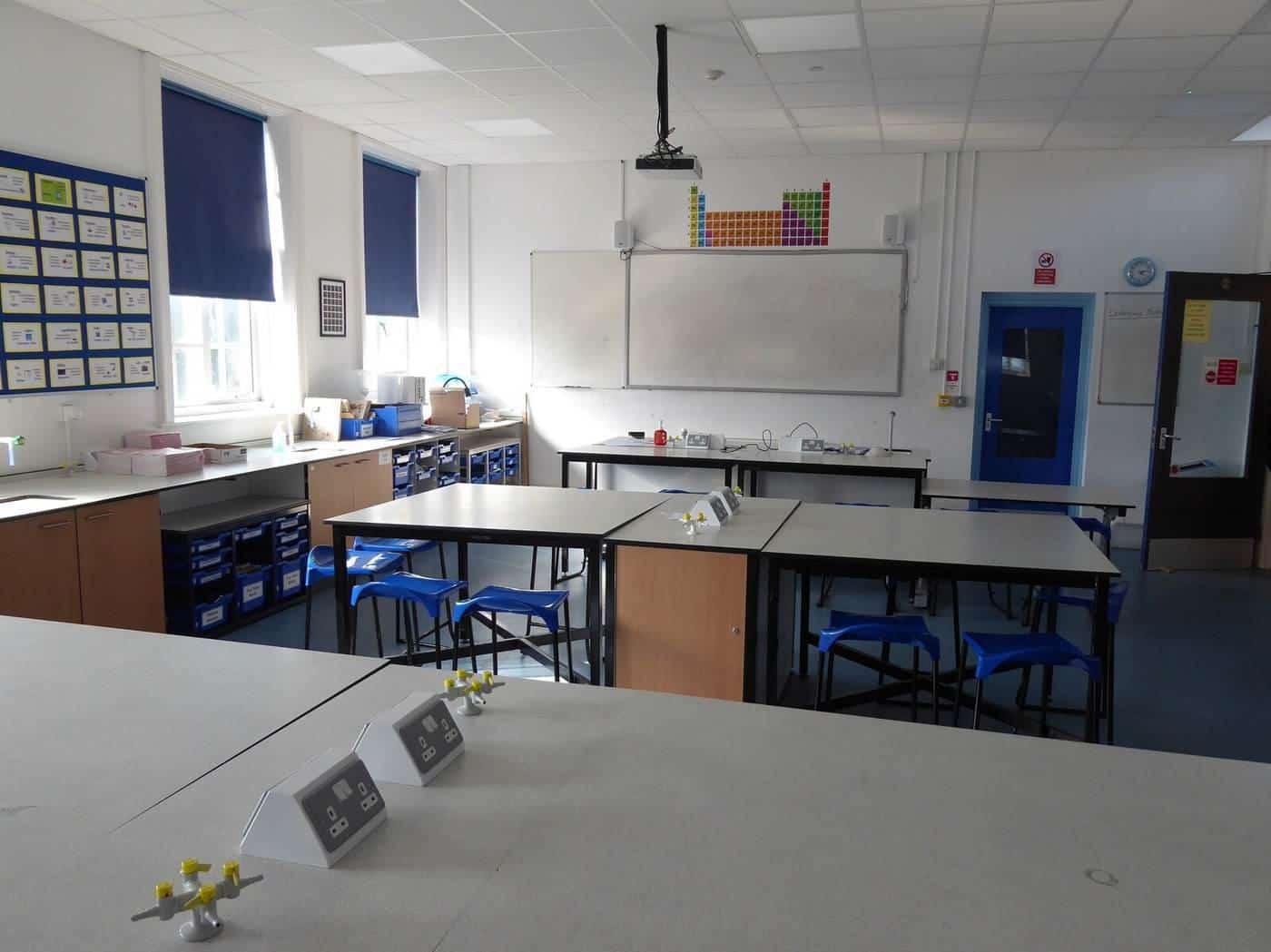 A school science laboratory with benches and stools