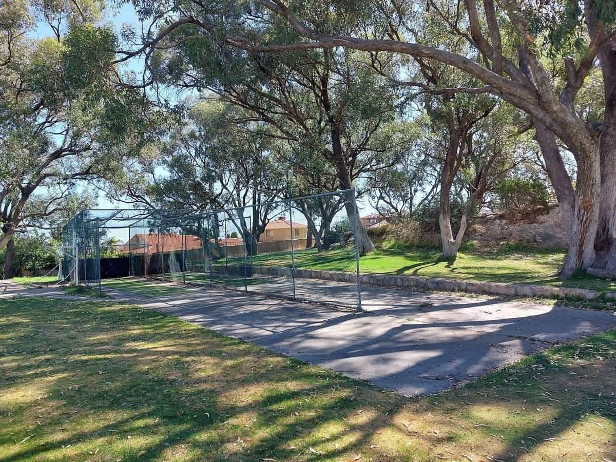 Cricket nets on a tree-lined school oval
